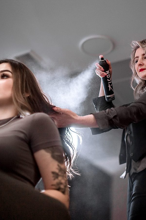 Peluquera echando laca en el pelo